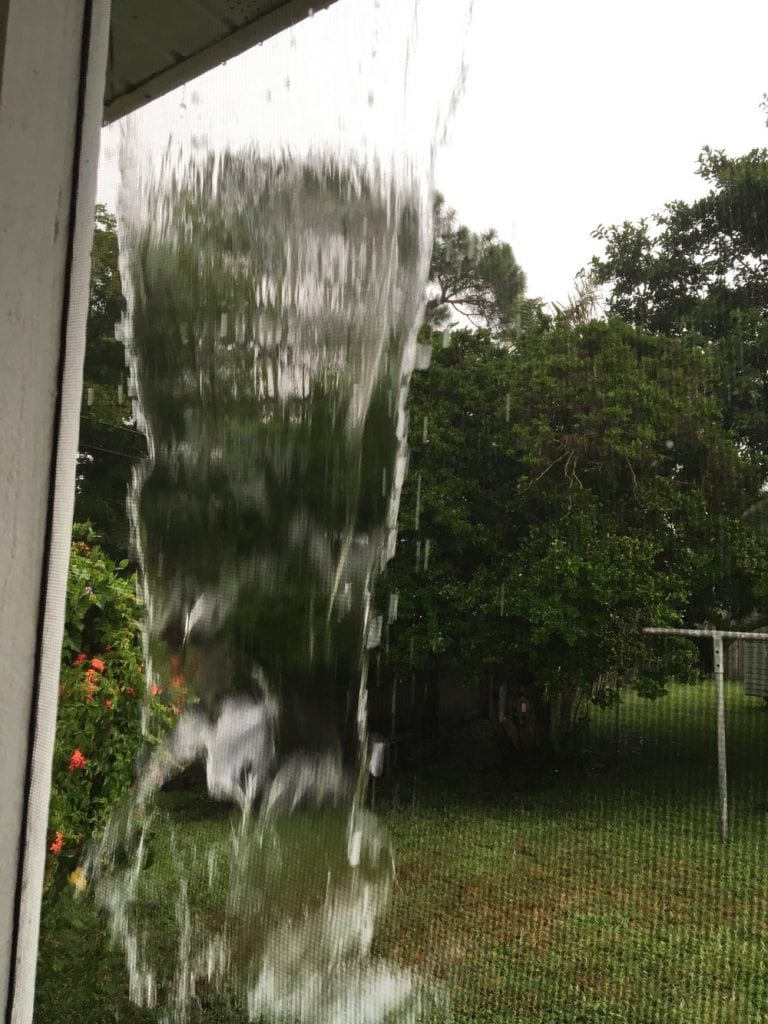 Sheet of water pouring off the roof