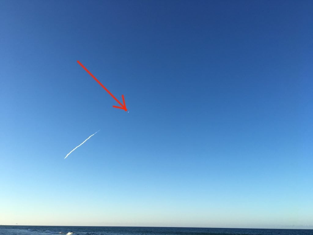 Rocket crossing the sky over the ocean