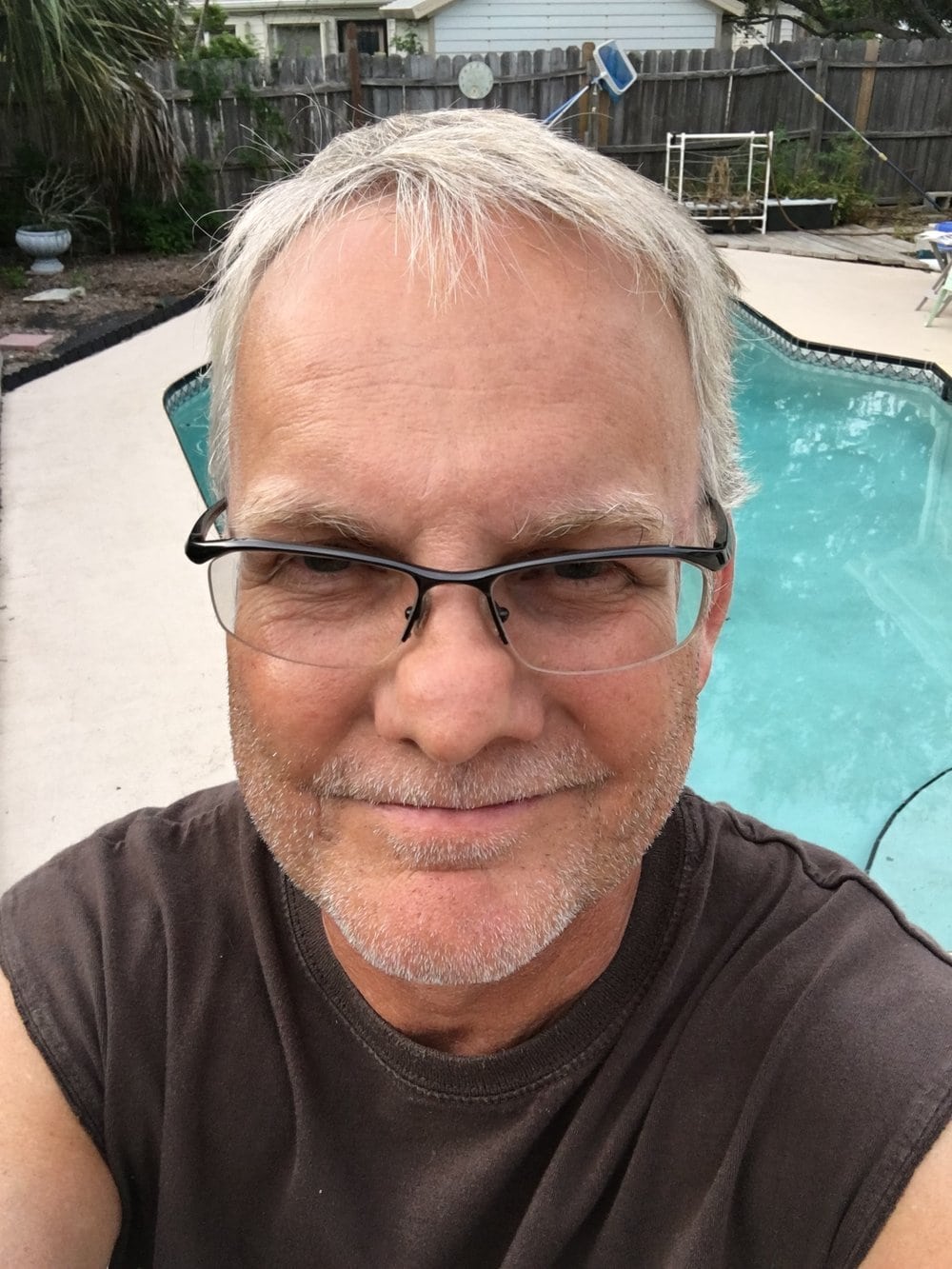 Norm with 3 day stubble, in front of swimming pool